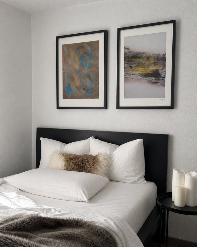 Happy Tortoise and Dusk Over Ridge prints above a bed