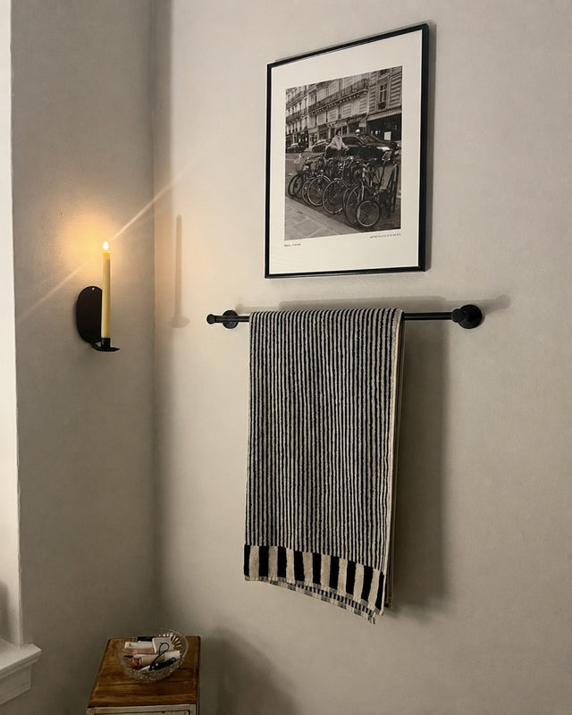 A Velo print above a towel rail