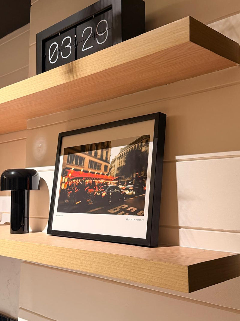 Kabir's After Afterworks print on a floating shelf at home
