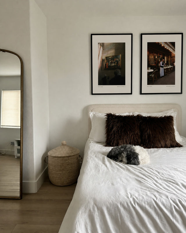 After the Ashes and Une P'tite Pause above a bed beside a mirror